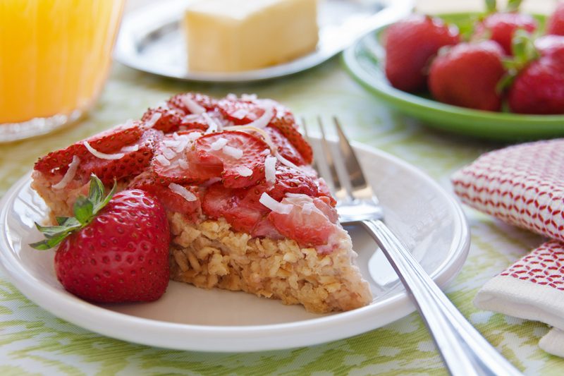 Strawberry Breakfast pie is packed with oats, yogurt and coconut then a layer of strawberries are arranged on top.